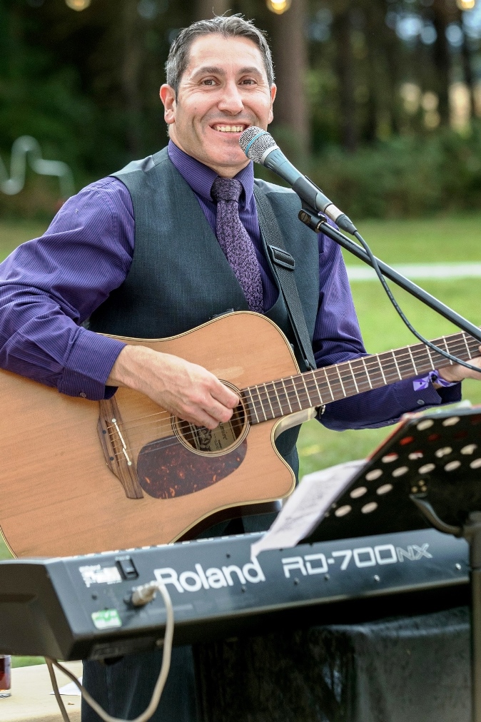 Antoine singing with guitar